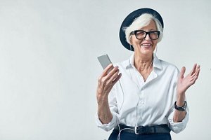 woman with grey hair wearing hat and glasses 